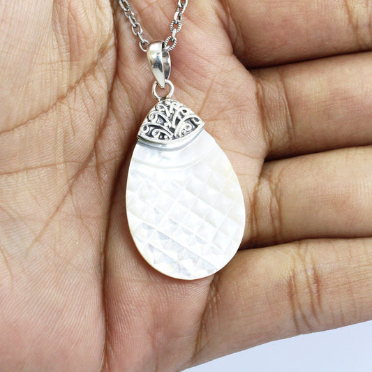 Tear drop pendant with genuine white shell set in 925 sterling silver decorated with Bali swirl filigree ornament
