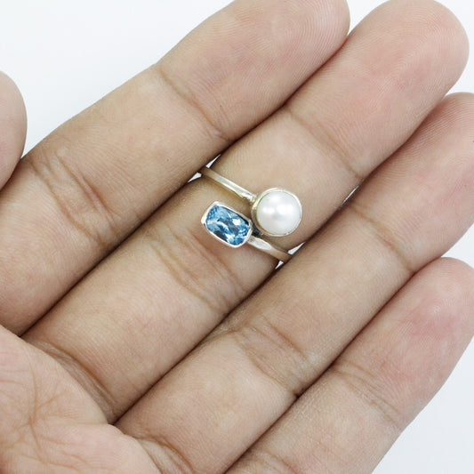 bypass ring with genuine blue topaz and freshwater pearl set in 925 sterling silver