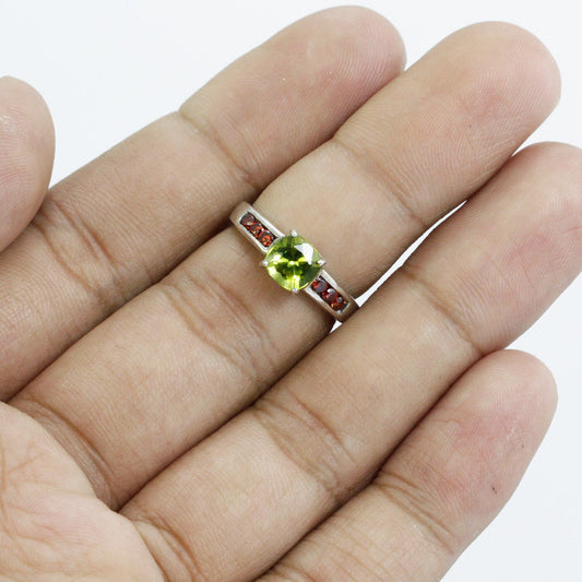 peridot ring  sterling silver decorated with red garnet solitaire style