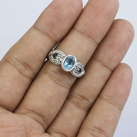 blue topaz ring set in 925 sterling silver decorated with cable ornament