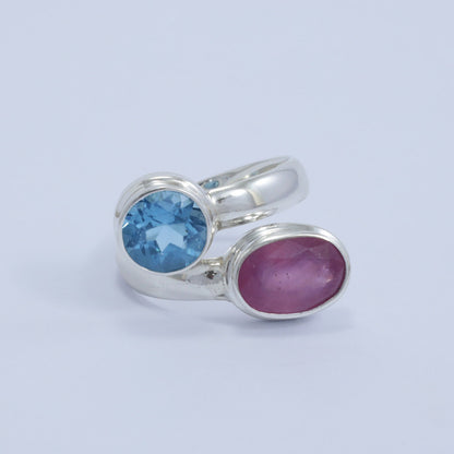 red ruby ring 925 sterling silver bypass style decorated with genuine blue topaz