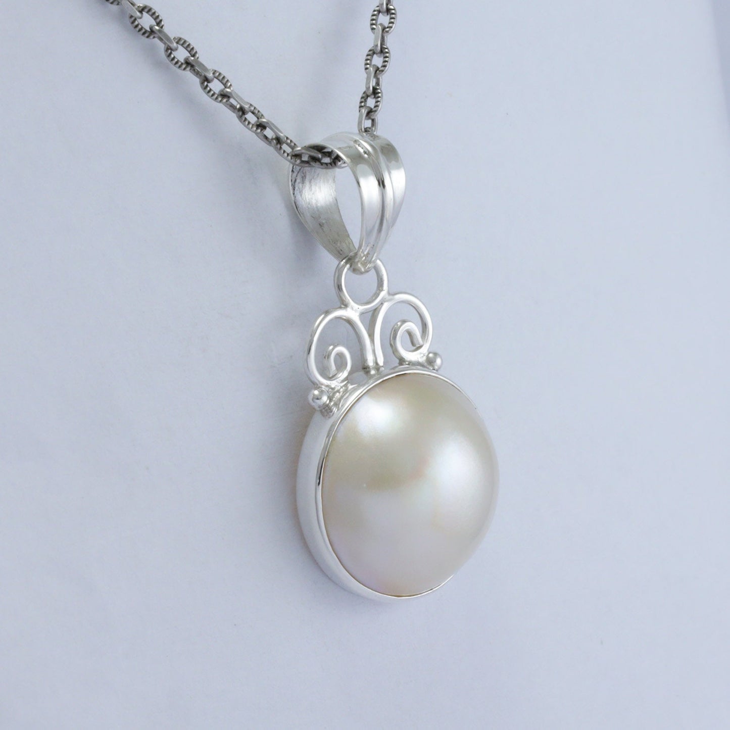 white Mabe pearl pendant necklace 925 sterling silver decorated with swirl filigree and bezel set