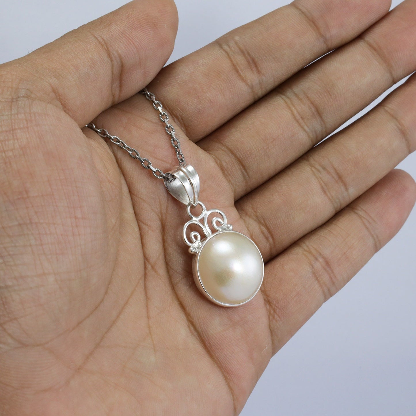 white Mabe pearl pendant necklace 925 sterling silver decorated with swirl filigree and bezel set