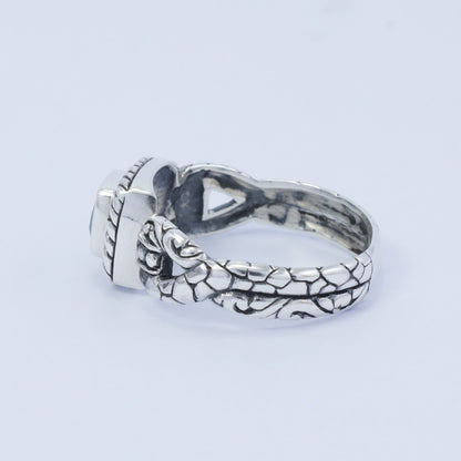 square ring with genuine blue topaz set in 925 sterling silver decorated with cable ornament