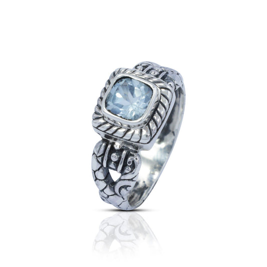 square ring with genuine blue topaz set in 925 sterling silver decorated with cable ornament