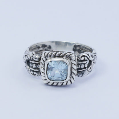 square ring with genuine blue topaz set in 925 sterling silver decorated with cable ornament