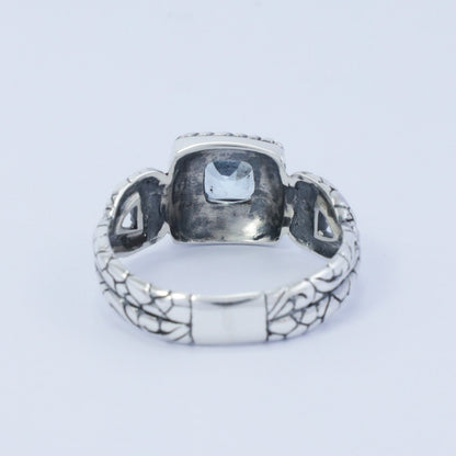 square ring with genuine blue topaz set in 925 sterling silver decorated with cable ornament