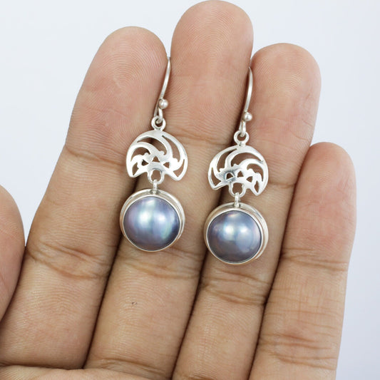 blue mabe pearl earrings set in 925 sterling silver decorated with ornament